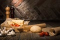 close up view of fresh cherry tomatoes, cheese, mushrooms and loaf of bread on baking paper Royalty Free Stock Photo
