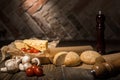 close up view of fresh cherry tomatoes, cheese, mushrooms and loafs of bread on baking paper Royalty Free Stock Photo