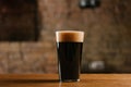 close-up view of fresh cold beer with foam in glass on wooden table Royalty Free Stock Photo