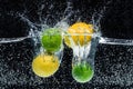 close up view of fresh lemons and limes in water