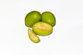 Cut Pieces of fresh green Spondias dulcis fruits on white isolated background