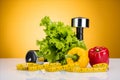 close-up view of fresh vegetables, measuring tape and dumbbells