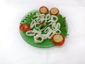 fresh whole cleaned Loligo Squid ring (Loligo Duvauceli) decorated with curry leaves , tomato,lemon slice and Royalty Free Stock Photo