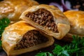 close-up view of a freshly baked bourekas filled with spiced ground beef and aromatic herbs, with a crispy exterior