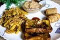 Close-up view of fried bread with blurred tasty pasta, vegetable roll and sweet khir on a plate