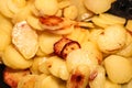 Close up view on fried potatoes during cooking Royalty Free Stock Photo