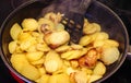 Close up view on fried potatoes during cooking Royalty Free Stock Photo