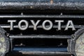 Close-up view of front old shabby grille of Toyota Land Cruiser Prado with inscription Toyota