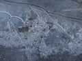 Close up view of frozen water in the puddle on the street. Caution, very slippery surface. Natural background