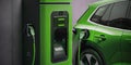 A close-up view of the future of sustainable transportation, this photo showcases a new green electric car being charged