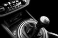 Close up view of a gear lever shift. Manual gearbox. Car interior details. Car transmission. Soft lighting. Abstract view. Black