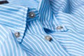 Close up view of a generic blue business shirt with a line pattern