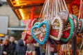 Gingerbreads with `Frohes Fest` means Merry Celebration are hang in front of stall shop in Christmas Market.