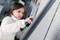 girl, child is wiping off the white board in class. Childhood concept Royalty Free Stock Photo