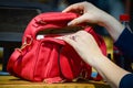 Woman hands opening red handbag