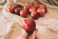 Close up view of girl holding red apple in hand. Organic fruit. Royalty Free Stock Photo