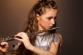 Close-up view of girl playing on silver flute Royalty Free Stock Photo