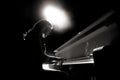 Close up view of a girl plays piano in the concert hall at the scene Royalty Free Stock Photo