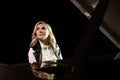 Close up view of a girl plays piano in the concert hall at scene Royalty Free Stock Photo