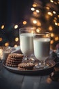 Close-up view of glasses of milk and chocolate cookies. Bokeh lights background.