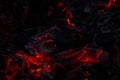 Glowing red embers and ash in dark fire remains Royalty Free Stock Photo