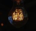 A close up view of the glowing tungsten wire in a light bulb