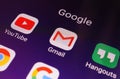 Close-up view of Google apps on an Android smartphone, including Gmail, YouTube, Hangouts