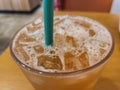 Close up view of grapefruit iced tea in a cup with straw