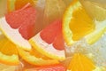 Close-up view of the grapefruit, orange fruit and honey pomelo slices in water background. Texture of cooling fruit Royalty Free Stock Photo
