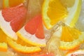 Close-up view of the grapefruit, orange fruit and honey pomelo slices in water background. Texture of cooling fruit Royalty Free Stock Photo