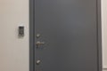 Close up view of a gray extra heavy metal door with an electronic combination lock.