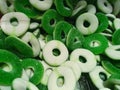 Close up view of green gummy fruit jelly ring in sugar, Candy background