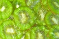 Close-up view of the green kiwi fruit slices in water background. Texture of cooling fruit drink with macro bubbles on Royalty Free Stock Photo