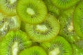 Close-up view of the green kiwi fruit slices in water background. Texture of cooling fruit drink with macro bubbles on Royalty Free Stock Photo