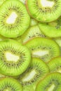 Close-up view of the green kiwi fruit slices in water background. Texture of cooling fruit drink with macro bubbles on Royalty Free Stock Photo