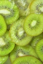 Close-up view of the green kiwi fruit slices in water background. Texture of cooling fruit drink with macro bubbles on Royalty Free Stock Photo