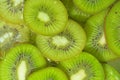 Close-up view of the green kiwi fruit slices in water background. Texture of cooling fruit drink with macro bubbles on Royalty Free Stock Photo