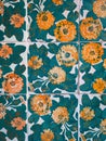 Close up view of green tiles with orange flowers inside Casa Vicens by GaudÃÂ­.