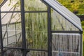 Close up view of greenhouse with condensation on windows walls.