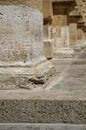 Close-up view of a grey stone pillar set at the base of an aisle in a building Royalty Free Stock Photo