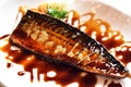 Close-up view, Grilled saba with teriyaki sauce on white plate.