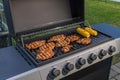 Close up view of grilling of corn and meat on outdoor gas grill. Healthy food concept.