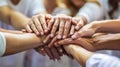 Close-up view of a group of diverse hands placed one on top of the other in a stack. AI generated Royalty Free Stock Photo