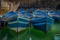 Close up view of a group of old traditional wooden blue fisherman boats.