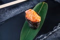 Close up view on gunkan sushi with spicy sauce and salmon on dark stone background. Fresh Japanese cuisine. asian food. Sushi Royalty Free Stock Photo