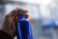 Close-up view of half reusable, aluminium thermo bottle for water in male hand.