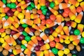 Close up view of Halloween candy corn and colorful chocolate candies Royalty Free Stock Photo