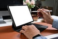 Hand of businessman holding stylus pen pointing on screen of computer tablet. Royalty Free Stock Photo