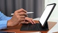 Close up view businessman holding stylus pen pointing on screen of computer tablet. Royalty Free Stock Photo