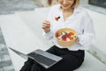 Close up view of hand of businesswomann having a vegetables salad for lunch, healthy eating Royalty Free Stock Photo